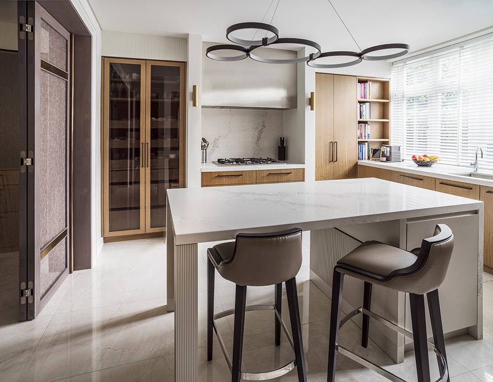 contemporary wood and marble kitchen with circular pendant lighting above kitchen island