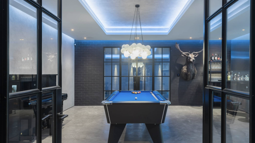 Entrance to sports bar via Crittall doors and concrete floor