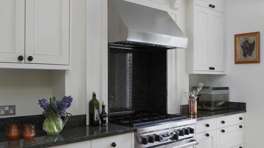 Custom built joinery with a stylish mottled black and mustard granite worktop.