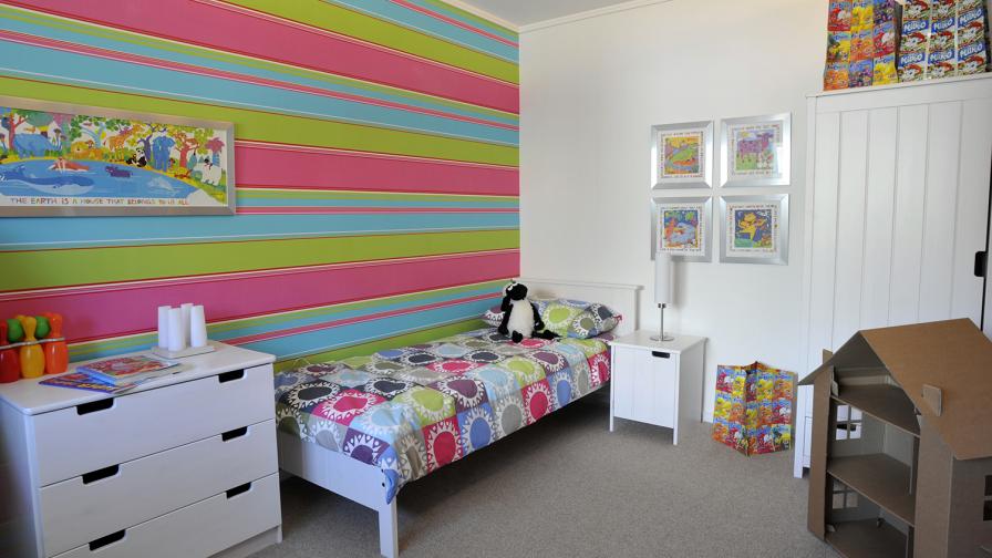 This child’s bedroom is finished in environmentally sensitive materials. The storage bags are made from recycled packaging.