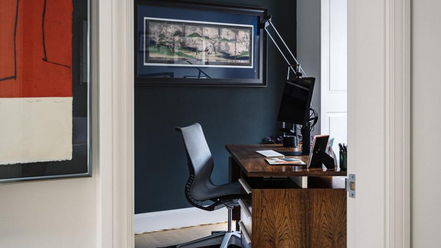 Deep blues and greens set off the glossy Mid-Century Modern desk in this home office