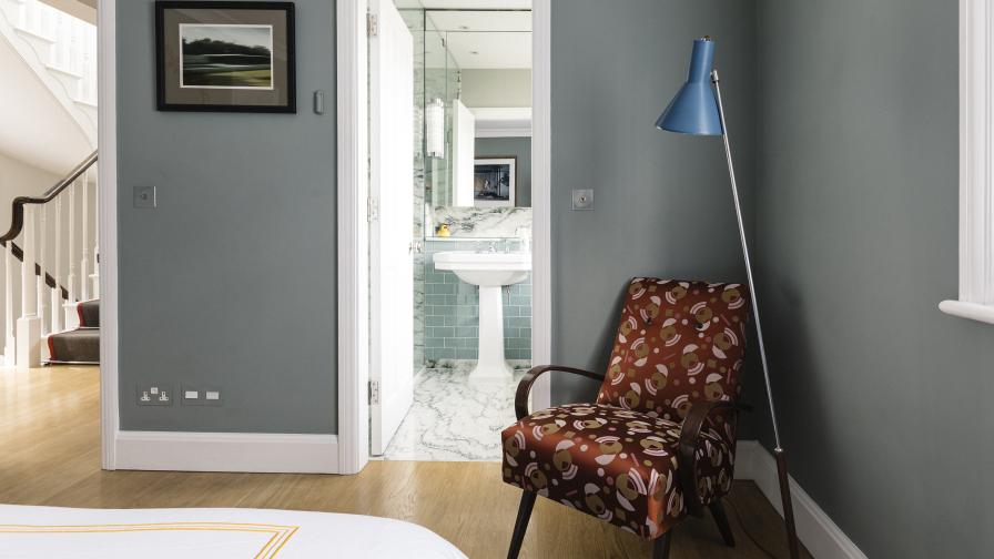 The restful guest bedroom allows a view to the Art Deco inspired en-suite bathroom.