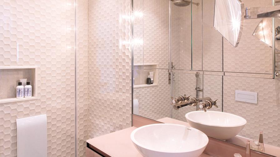 Steam room, pink and taupe, ceramic tiles and glass vanity unit. Nickel and mother of pearl brassware