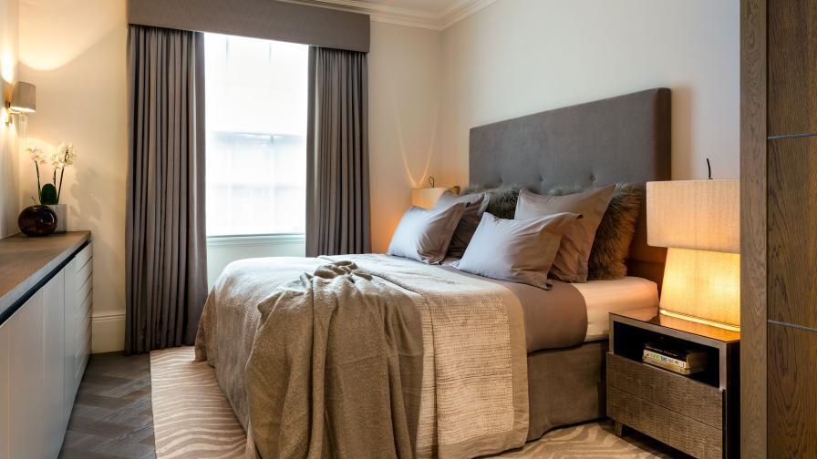 Classic, calm bedroom in textured taupe and cream