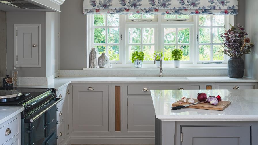 Shaker style Kitchen with Aga in a grey and plum colour scheme.