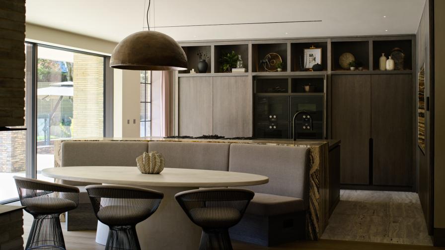 A grey stained oak minimalist style kitchen with dining table & banquette seating