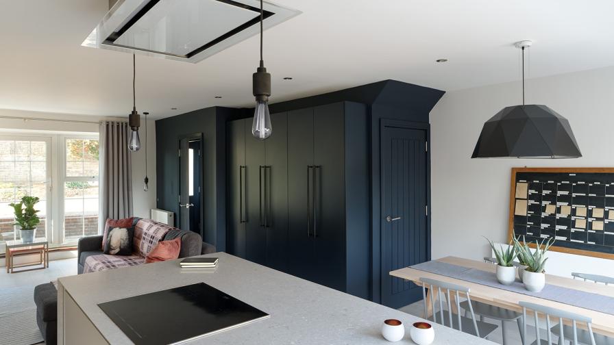 kitchen island; ceiling mounted extractor; wall of storage