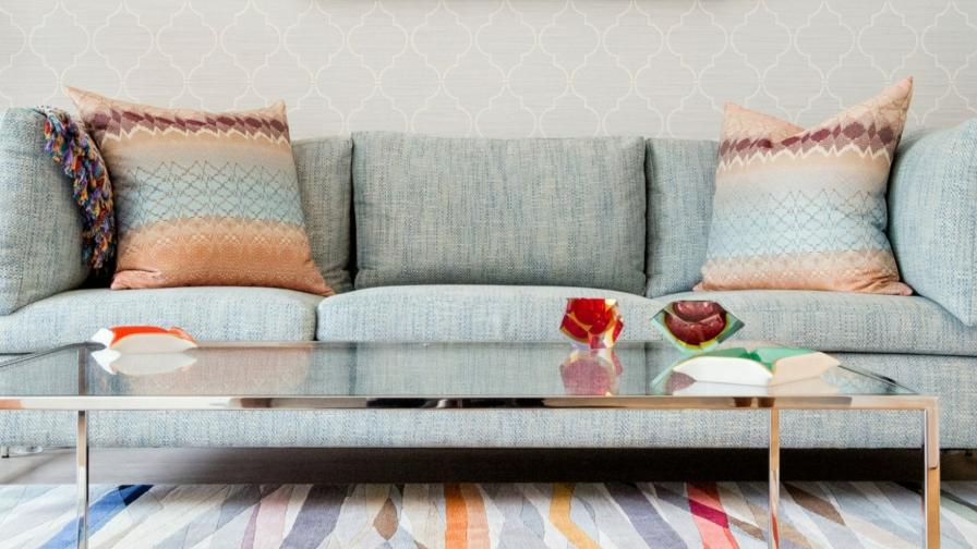 Colourful slices of colour run throughout the rug. The Missoni cushions add a playful touch to the cool blue sofa.