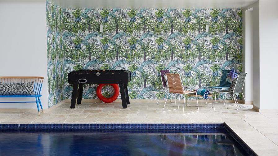 Swimming pool; bespoke mural; bespoke wall paper; table football; blue mosaics; Ercol bench