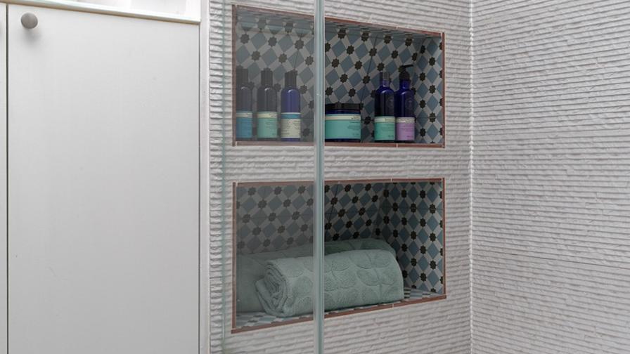 Spacious shower using the eves for storage; shower under eaves; walk in shower; patterned floor tiles; clever bathroom storage