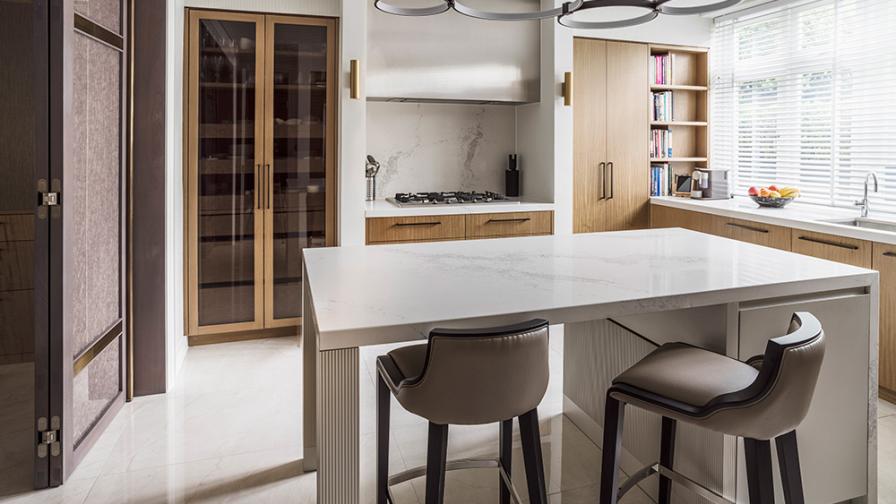 contemporary wood and marble kitchen with circular pendant lighting above kitchen island