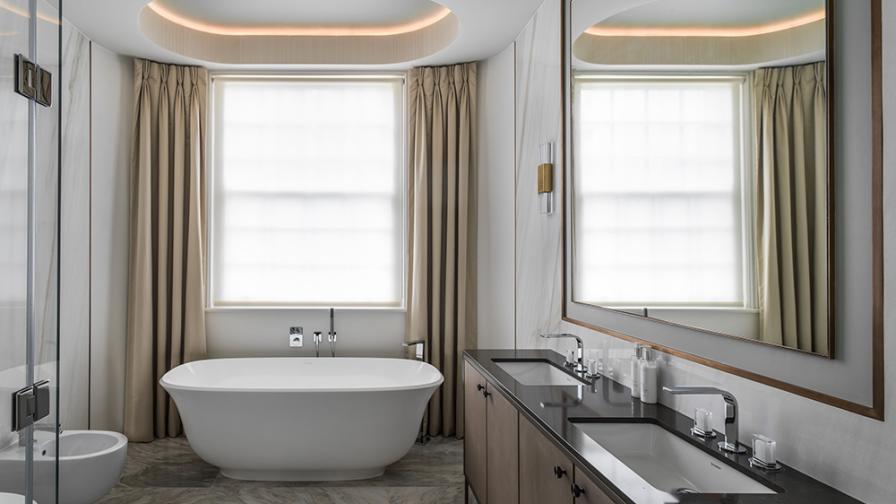 luxury bathroom with large bay window, dress curtains and oval freestanding bath