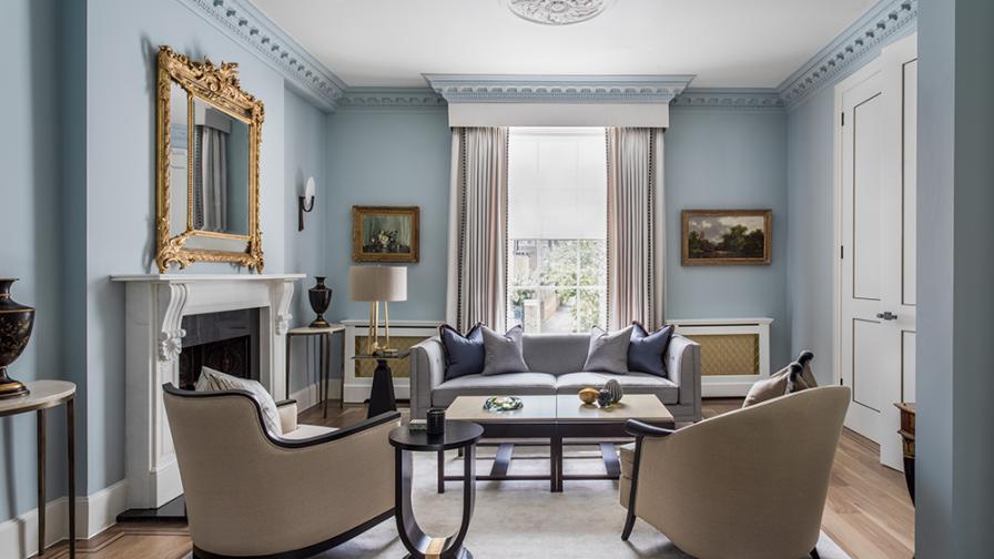 elegant reception room with classic-contemporary furniture and pale blue walls