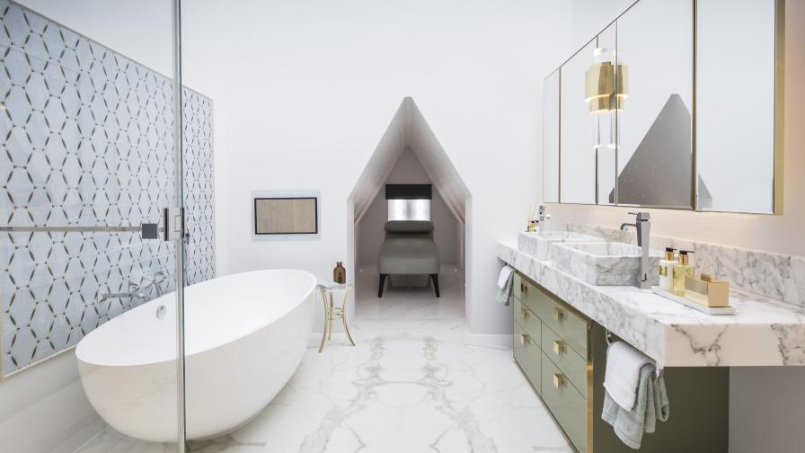 spa-like bathroom with large oval freestanding bath, marble vanity and daybed