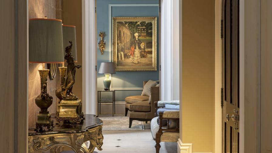 luxurious entrance hall with ornate console table and tall table lamps