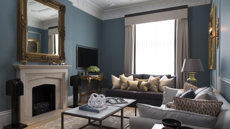 elegant blue living room with classic contemporary furniture and fireplace