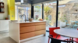 Contemporary kitchen extension  and courtyard garden in period Victorian property 
