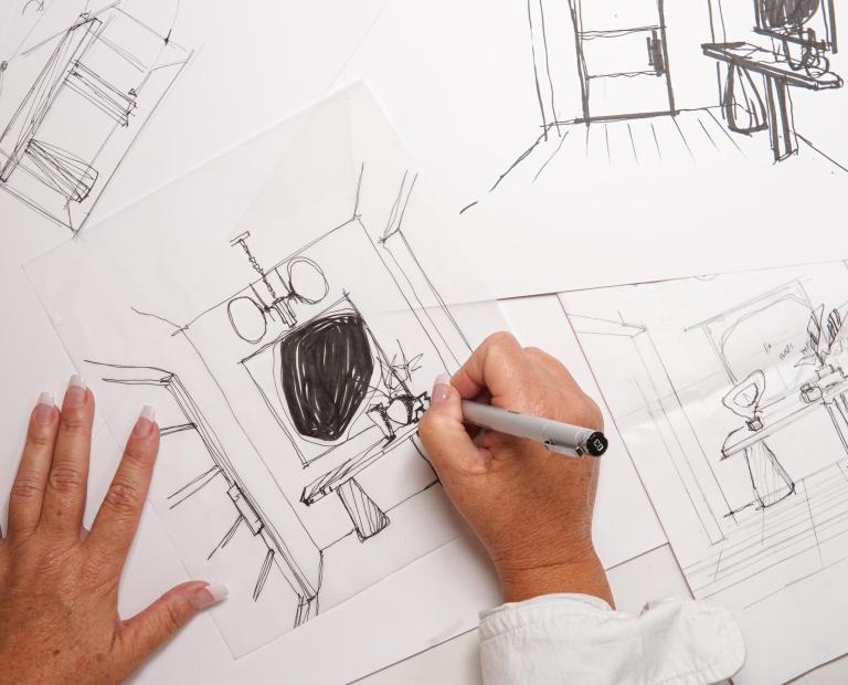 Someone drawing a design plan