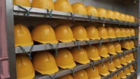 rows of yellow hardhats sit on shelves