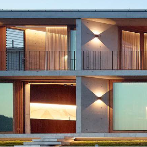 view of concrete home with balcony and windows
