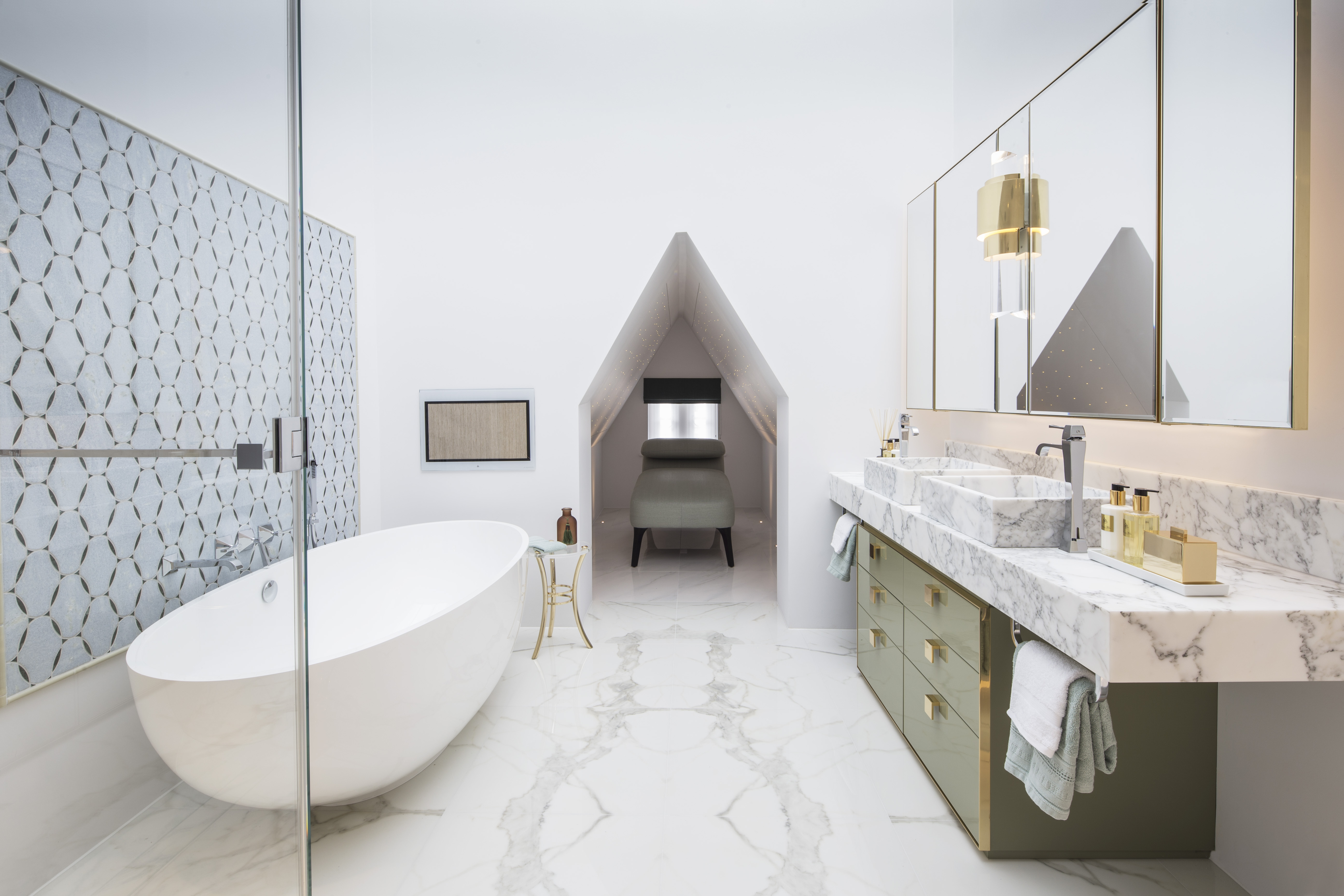 spa-like bathroom with large oval freestanding bath, marble vanity and daybed