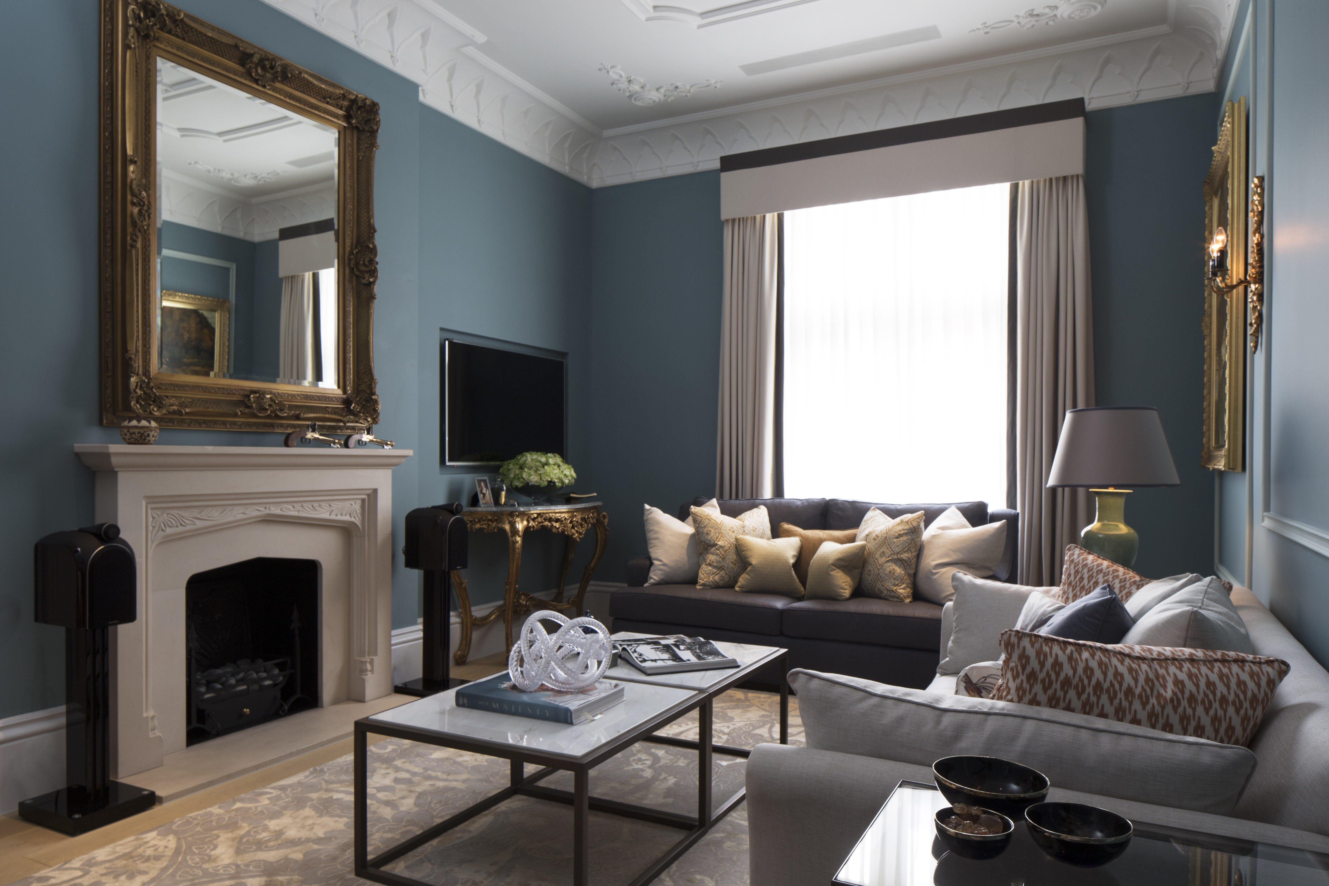 elegant blue living room with classic contemporary furniture and fireplace